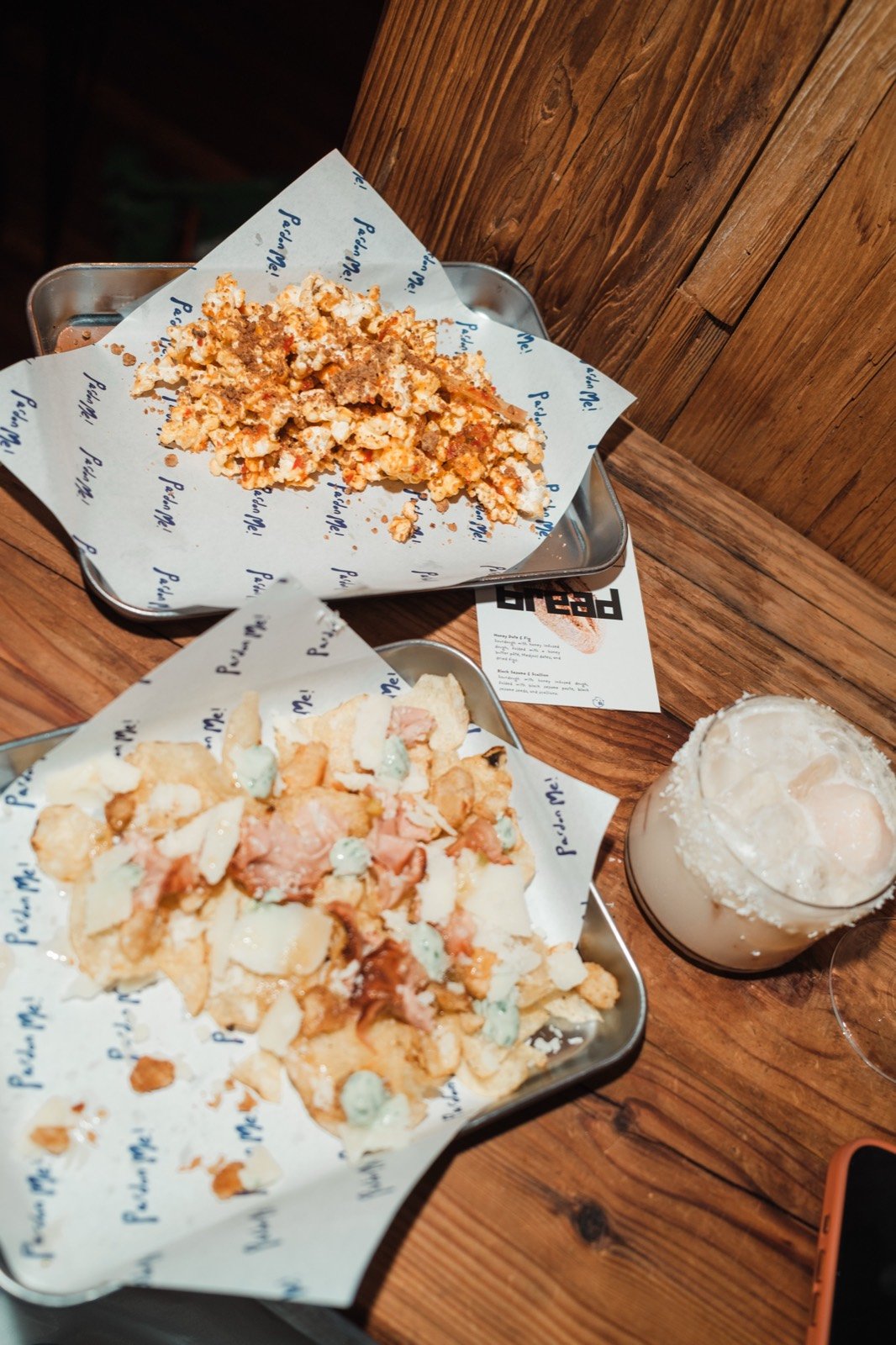 Popcorn, Basque nachos, and cocktails on branded paper